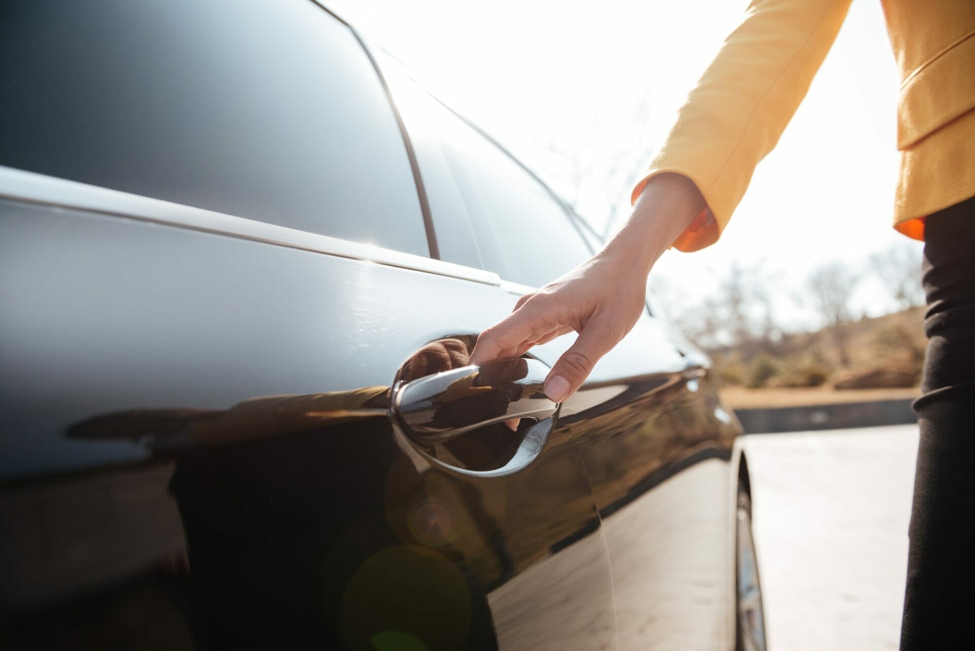 Businesswomen opening the door of black car